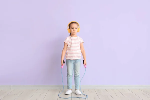 Cute Little Girl Headphones Jumping Rope Color Background — Stock Photo, Image