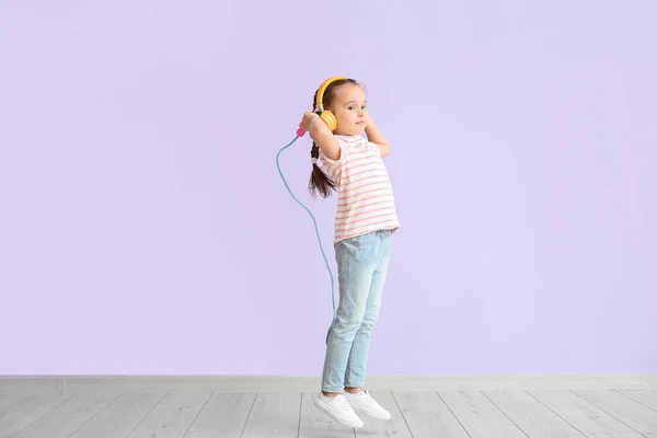 Cute Little Girl Headphones Jumping Rope Color Background — Stock Photo, Image