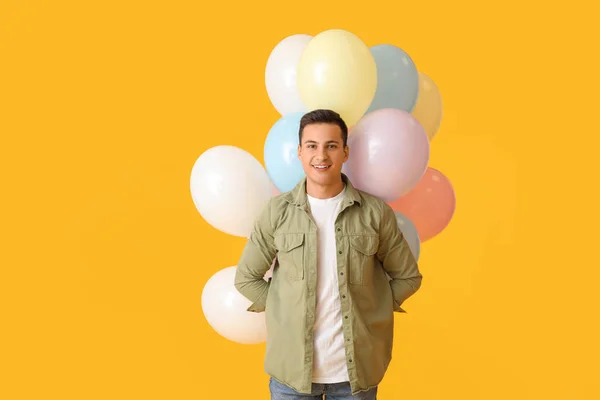 Young Man Balloons Color Background — Stock Photo, Image
