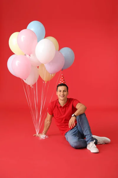 Young Man Balloons Party Hat Color Background — Stock Photo, Image