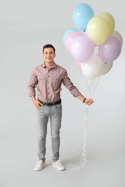 Young Man Balloons Grey Background — Stock Photo, Image