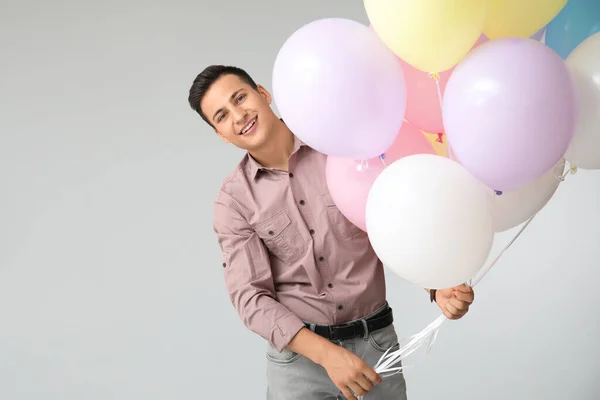 Young Man Balloons Grey Background — Stock Photo, Image