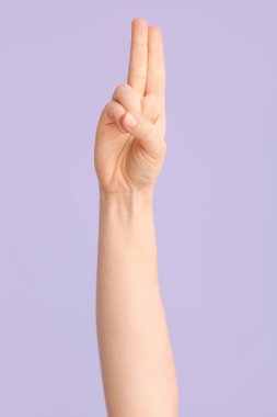 Renk arkaplanında U harfini gösteriyor. İşaret dili alfabesi