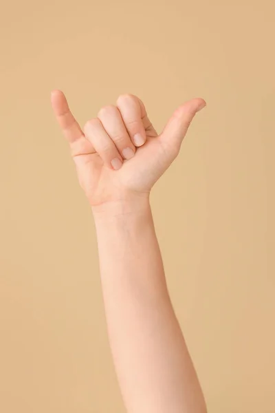 Hand showing letter Y on color background. Sign language alphabet