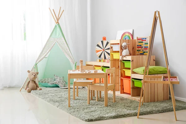 Interior of modern children\'s room with play tent and toys