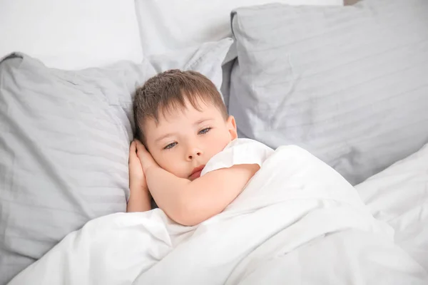 Little boy suffering from sleep disorder in bedroom