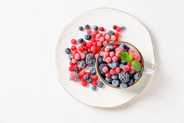 Cup Plate Tasty Frozen Berries White Background — Stock Photo, Image