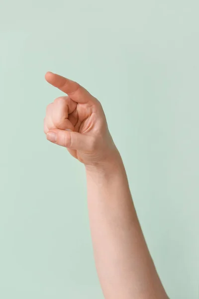 Hand showing letter Z on color background. Sign language alphabet