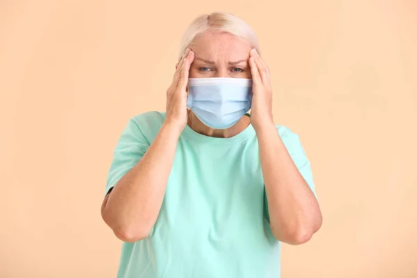 Stressed Mature Woman Wearing Medical Mask Color Background — Stock Photo, Image