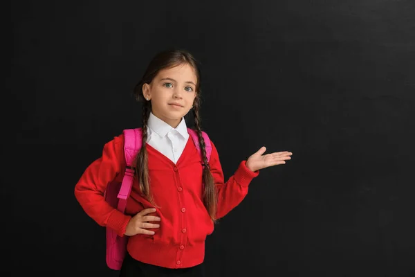Little Schoolgirl Showing Something Dark Background — Stock Photo, Image