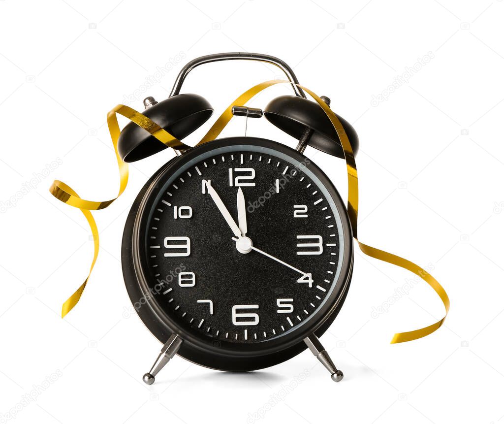 Alarm clock and golden ribbon on white background. Christmas time