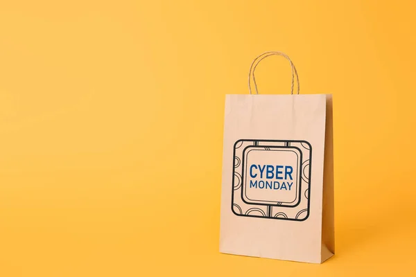 Paper shopping bag with text CYBER MONDAY on color background