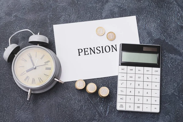 Paper Sheet Word Pension Coins Alarm Clock Calculator Dark Background — Stock Photo, Image