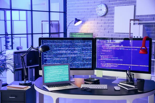 Workplace of programmer in office at night