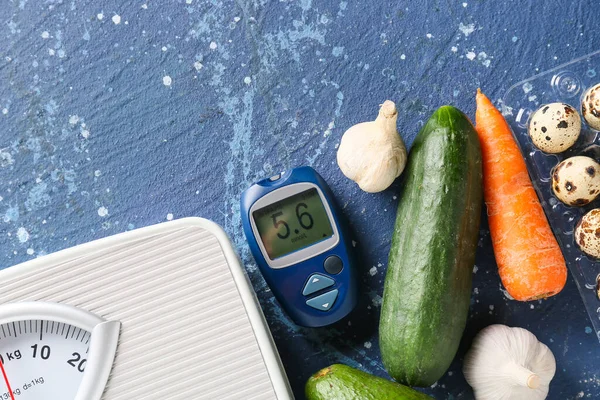 Vegetables, scales and glucometer on color background. Diabetes concept