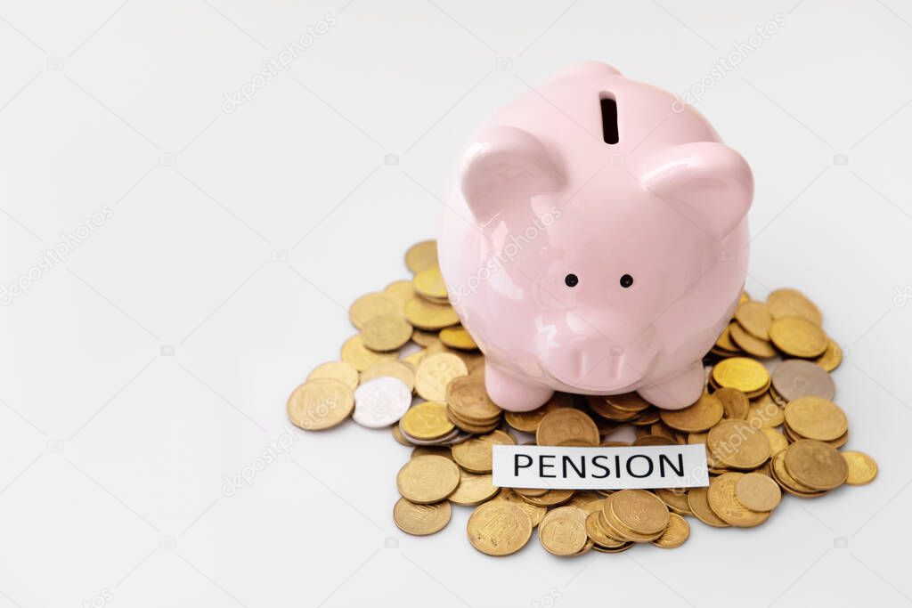 Piggy bank with coins and word PENSION on white background
