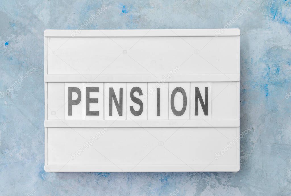 Board with word PENSION on color background