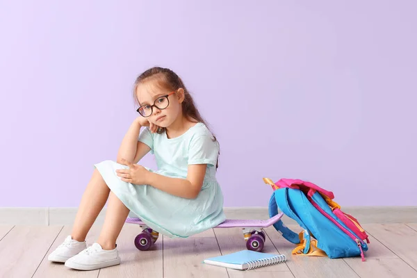 Little Schoolgirl Sitting Skateboard Color Wall — Stock Photo, Image