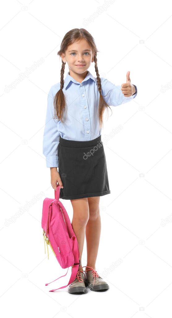Little schoolgirl showing thumb-up on white background