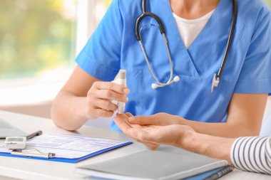 Diyabetli adam klinikte doktoru ziyaret ediyor.