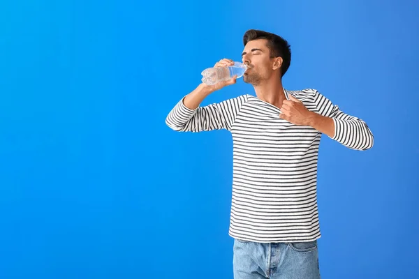 Man with problem of excessive thirst on color background. Diabetes symptoms