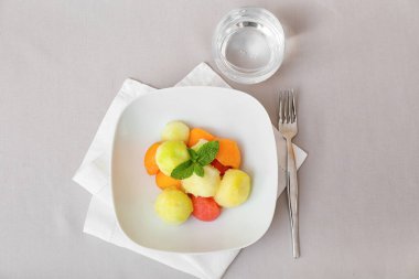 Masada lezzetli kavun topları olan bir tabak.