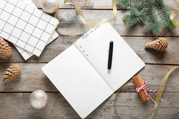 Empty to do list with Christmas decor on wooden background