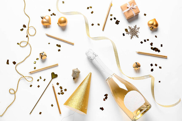 New Year composition with bottle of champagne on white background