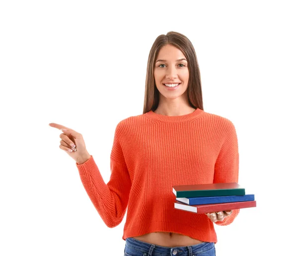 Hermosa Joven Con Libros Apuntando Algo Sobre Fondo Blanco — Foto de Stock