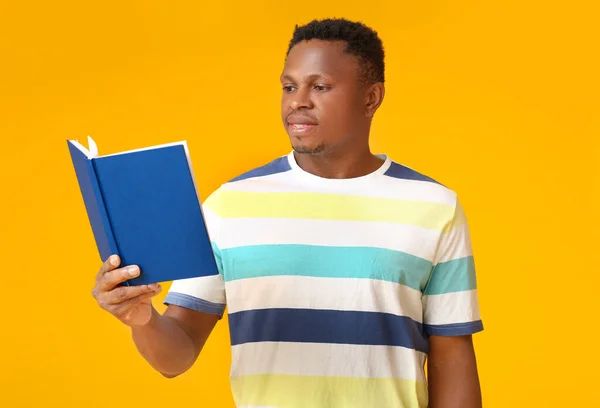 African American Man Reading Book Color Background — Stock Photo, Image