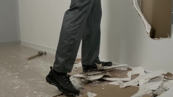 Männlicher Bauarbeiter Durchbricht Wand Aus Gipskartonplatten Haus — Stockvideo
