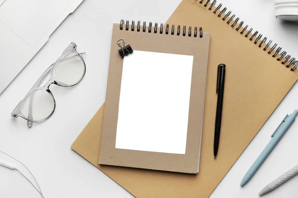 Composition with blank card and stationery on white background