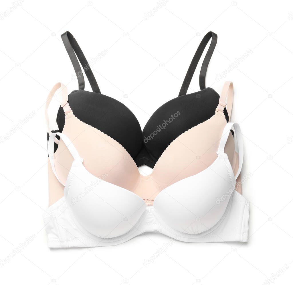 Stylish female bras on white background