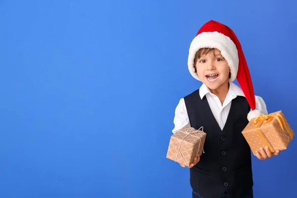 Cute Little Boy Santa Hat Gift Boxes Color Background — Stock Photo, Image