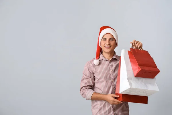 Handsome Man Santa Hat Shopping Bags Grey Background — Stock Photo, Image