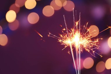 Karanlık arka planda, bulanık ışıkları olan güzel Noel kıvılcımları