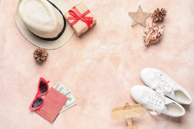 Renkli arkaplanda Noel dekoru, hediye, pasaport ve plaj aksesuarları olan kompozisyon