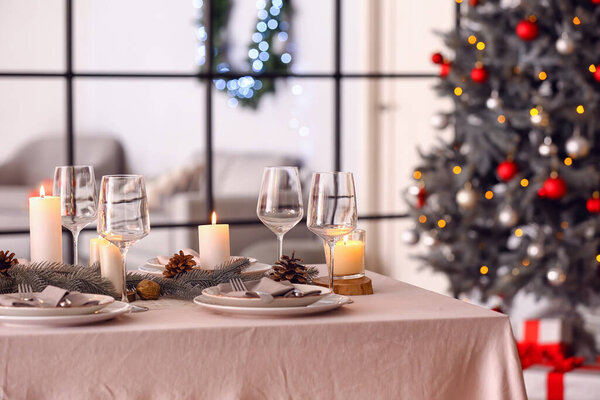 Beautiful table setting with Christmas decorations in living room