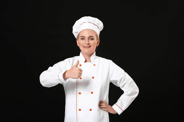 Mature Female Chef Showing Thumb Dark Background — Stock Photo, Image