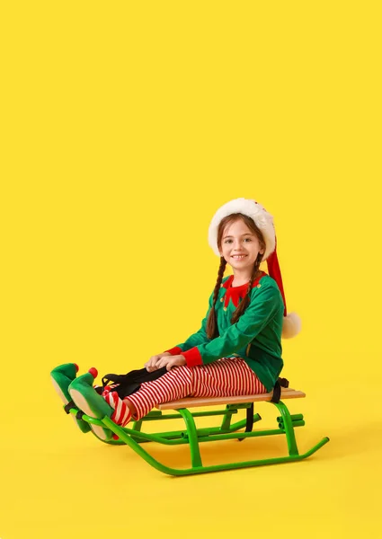 Cute Little Girl Dressed Elf Sitting Sledge Color Background — Stock Photo, Image