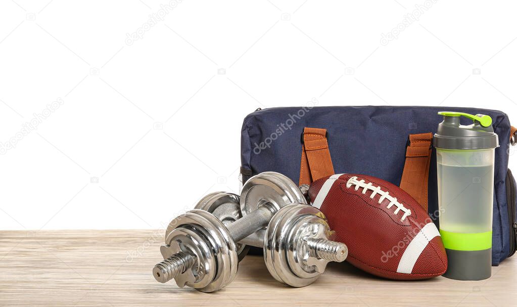 Set of sport equipment on table against white background