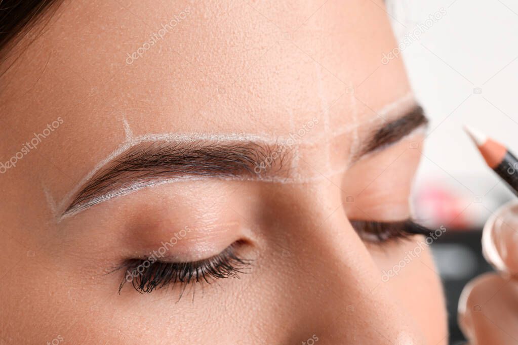 Young woman undergoing eyebrow correction procedure, closeup