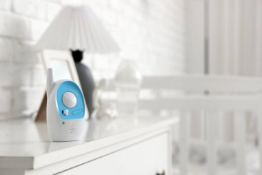 Baby monitor on chest of drawers in nursery, closeup