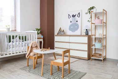 Interior of nursery with crib, shelf unit and toys