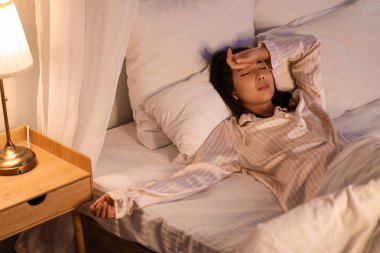Beautiful Asian woman sleeping in bedroom at night