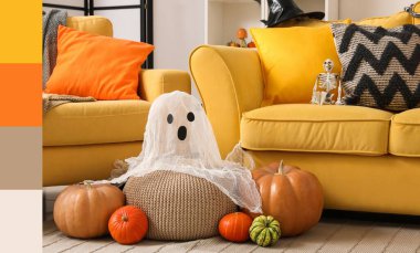 Halloween pumpkins and ghost near yellow sofas in room. Different color patterns