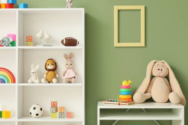 Interior of children's room with shelf unit, table and toys