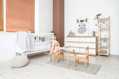 Interior of nursery with crib, shelf unit and toys