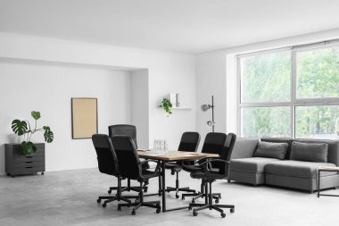 Interior of conference hall with table, lamp and sofa