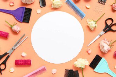 Set of hairdresser's accessories with roses and blank card on orange background